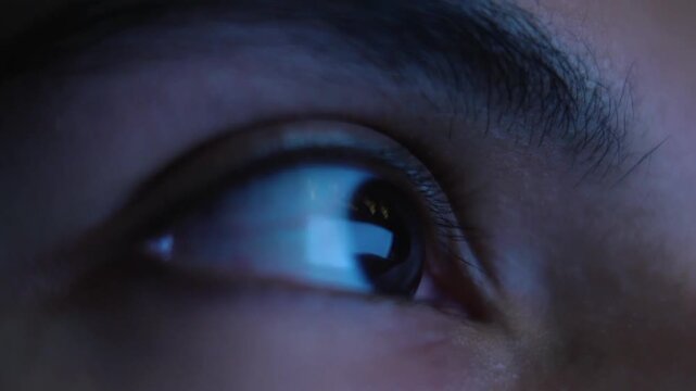 Close up of human eye with digital screen reflection