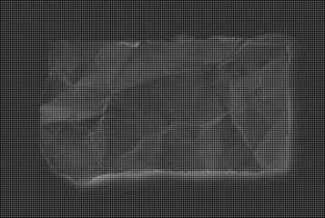 Fototapeta premium The crumpled paper is lit from within on a dark background.