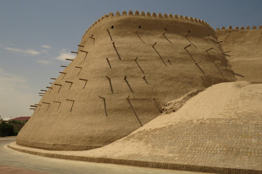 Historic defensive wall of Itchan Kala in the city of Khiva. Uzbekistan. Built with mud bricks and coated with a mixture of mud and straw. World Heritage Site.