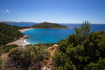 Fototapeta premium Trachili beach with wild herbs and white flowers in May, Aegean Sea, Chios, Greece, 
