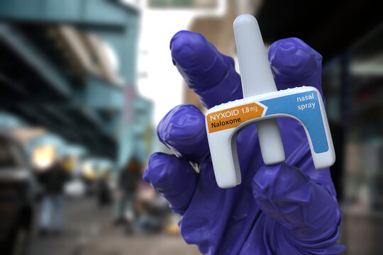A doctor holds Nyxoid, a naloxone nasal spray used for emergency opioid overdose reversal. This product is used in healthcare, addiction treatment, public health, and pharmaceuticals. 