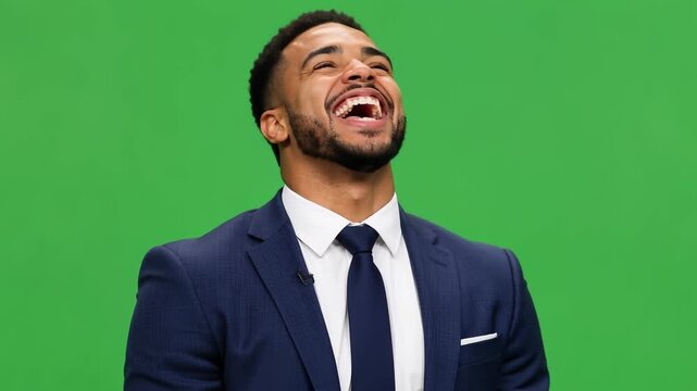 Man in Navy Suit Laughing Heartily, Head Tilted Back with Joy, Isolated on Green Screen Background