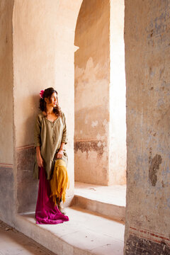 Woman Standing in a Sunlit Archway