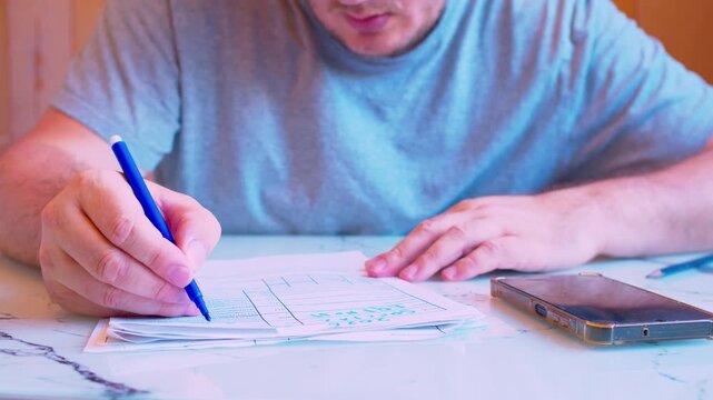 Cinematic close-up shot of carefully filling a form with a felt tip pen at home. Defocused background, soft window light. Visualizes tax preparation, corporate auditing, legal agreement.