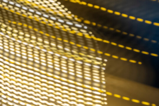 Dynamic abstract composition with amber and white light trails. Features rhythmic dotted patterns and motion blur using ICM. Sleek metallic texture with high energy for modern design.