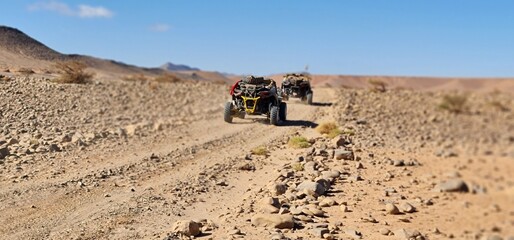 Low Angle Tracking Shot of Dune Buggies on Rocky Desert Trail   © Qisse