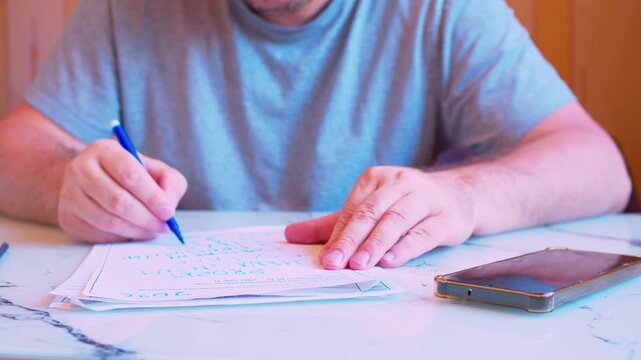 Cinematic shot of a male silhouette carefully filling out an official form or contract at a desk under natural light.