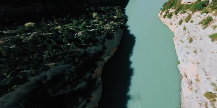 Dynamic FPV Drone Shot Flying Through Deep Volcanic Rck Canyon and River