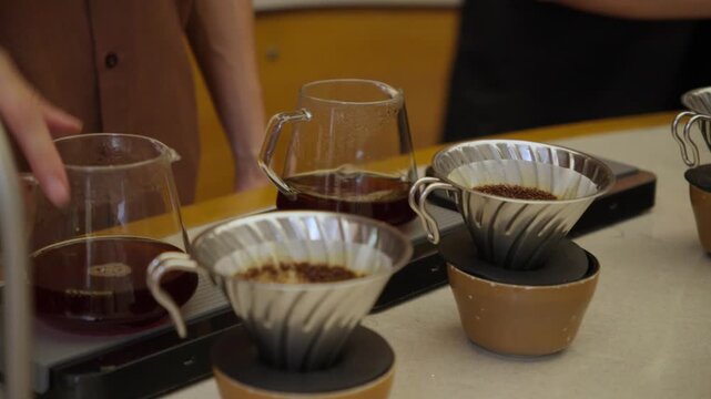 Barista preparing specialty drip coffee in a modern cafe