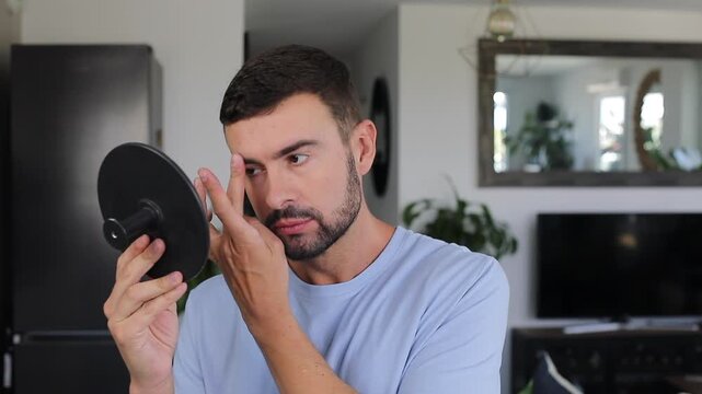A handsome man looking on the mirror 