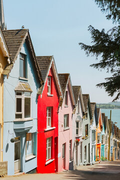 Iconic colorful homes in Cobh Ireland with St Colman's Cathedral