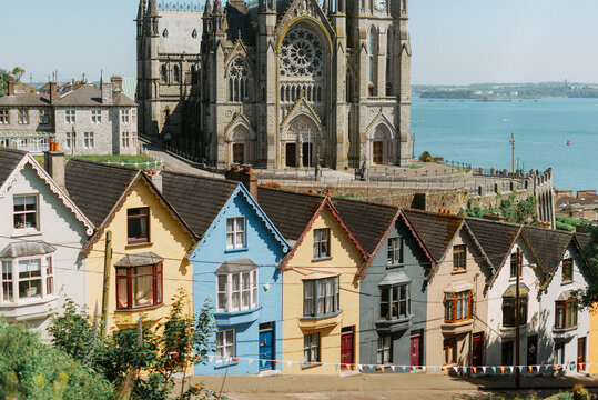 Colorful houses beneath St Colman's Cathedral in Cobh County Cork Ireland