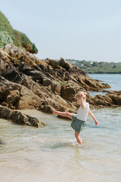Young Girl Playing on the Beach in a Sandy Cove in Ireland