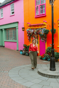 Female Walking Down a Historic Village Street Corner in Kinsale Ireland