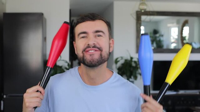 Man holding colorful juggling clubs