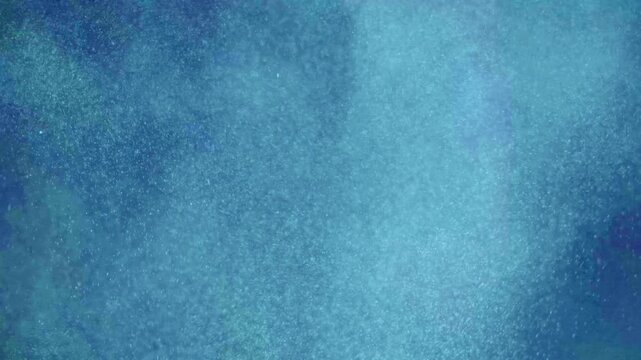 Abstract blue textured background with soft light diffusion and subtle grain.