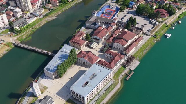 Visegrad, Bosnia and Herzegovina &ndash; May 30, 2026: Close aerial perspective of Andricgrad showcasing its architecture beside the Drina River