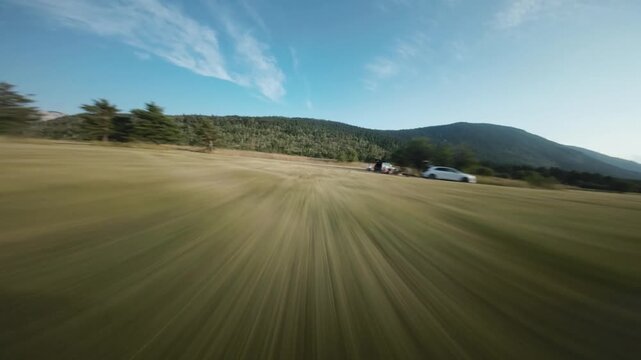 FPV Drone Shot Flying Fast and Low Over Field with Moion Blur