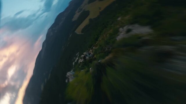FPV Drone Shot Diving Down Steep Rocky Mountain Slopeat Sunset