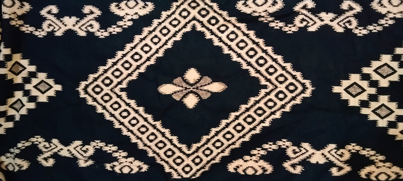 Black and white geometric rhombus pattern, featuring the detailed texture of elegant ethnic woven fabric for background or textile material.