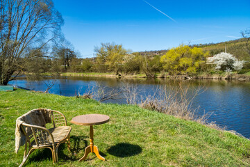 Fototapeta premium Modern design of garden furniture stands by the river, for relaxation. Czech