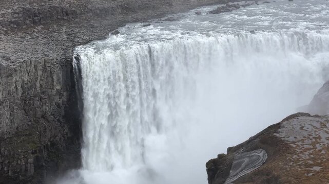 Majestic Dettifoss waterfall, Europe's most powerful cascade, flowing through a rugged canyon in Vatnajokull National Park, Iceland