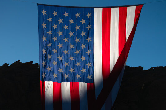 Close-Up of Giant American Flag Hanging Against Blue Sky and Desert Cliffs to Celebrate Patriotism and the 4th of July for the United States 250 Celebration 04