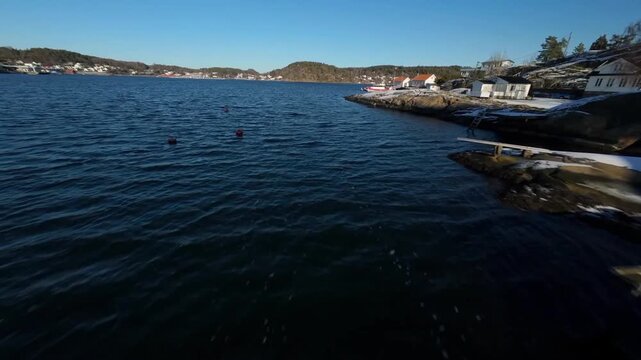 Aerial Low Angle View of Rocky Winter Coastline and Nrdic House