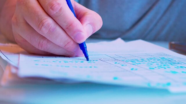 Cinematic macro of a hand filling a survey or job application form. Defocused background, soft window light. Visualizes questionnaire, voting, human resources hiring process and research.