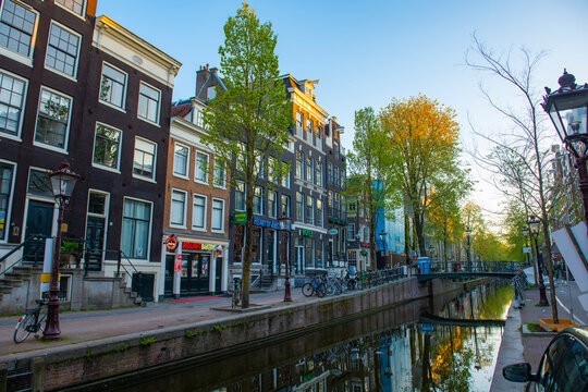 Red Light District (De Wallen) on Oudezijds Achterburgwal canal in central Amsterdam, Netherlands. Canal Ring Area of Amsterdam is designed as a UNESCO World Heritage Site.  