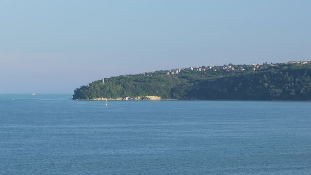 Sailing boat navigating near the victory lighthouse in the gulf of trieste