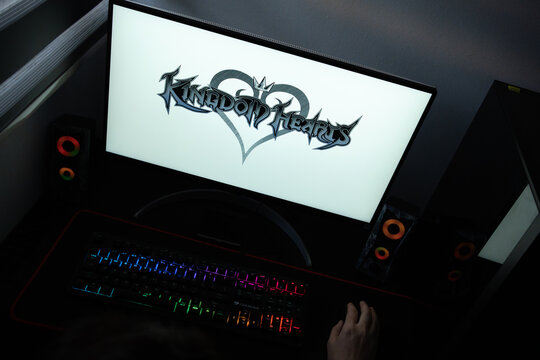 Punta Arenas, Chile &ndash; June 12, 2026: A desktop PC monitor showing the Square Enix Kingdom Hearts branding on a white background, surrounded by an illuminated gaming keyboard and peripherals