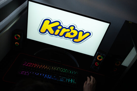 Punta Arenas, Chile &ndash; June 12, 2026: A desktop PC monitor showing the Nintendo Kirby character branding on a white background, surrounded by an illuminated gaming keyboard and peripherals