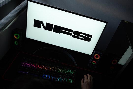 Punta Arenas, Chile &ndash; June 17, 2026: A desktop PC monitor showing Electronic Arts' Need for Speed racing franchise branding on a white background, surrounded by an illuminated gaming keyboard