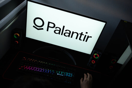 Punta Arenas, Chile &ndash; June 17, 2026: The official black typographic logo and geometric emblem of Palantir Technologies displayed on a computer screen in a dark room workspace setup