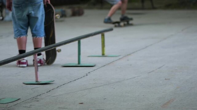 Skateboarder falling on the ground after attempting a trick at a skatepark