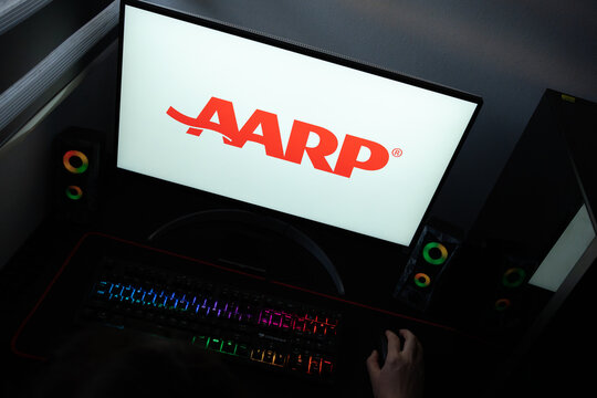 Punta Arenas, Chile &ndash; June 12, 2026: A desktop PC monitor showing the American Association of Retired Persons (AARP) emblem, surrounded by gaming peripherals