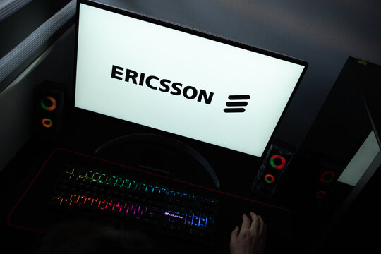 Punta Arenas, Chile &ndash; June 12, 2026: A desktop PC monitor showing the Ericsson corporate branding on a white background, surrounded by an illuminated gaming keyboard and peripherals