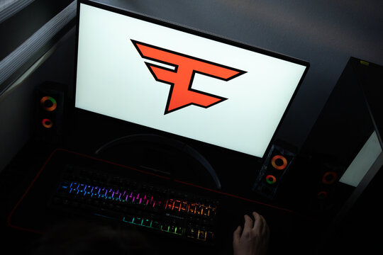 Punta Arenas, Chile &ndash; June 12, 2026: A desktop PC monitor showing the stylized FaZe Clan gaming brand emblem on a white background, surrounded by an illuminated gaming keyboard and peripherals