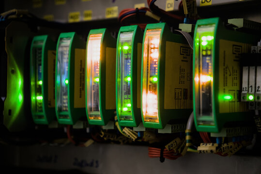 Conceptual close up of glowing LED indication on modular electronic components inside automation control system