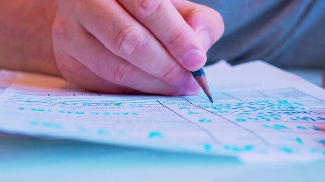Cinematic macro of a hand filling a survey or job application form. Defocused background, soft window light. Visualizes questionnaire, voting, human resources hiring process and research.