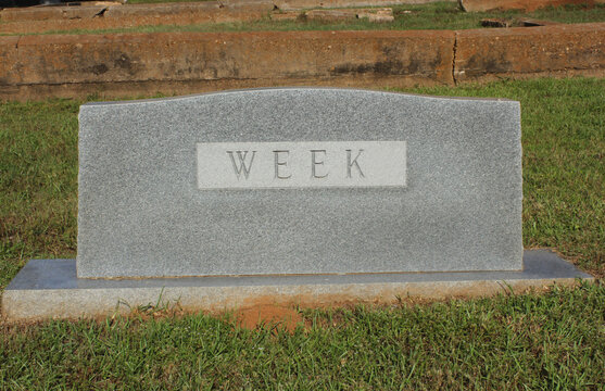 Headstone in Cemetery With Word Week Engraved