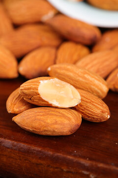 Fresh Roasted Almonds with Cracked Kernel on Wood