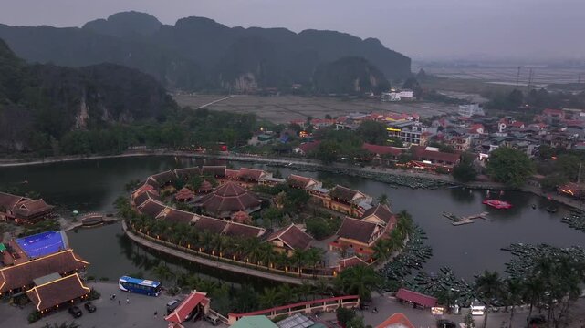 Aerial view of Tam Coc, a Historic Old Town Island in evening, Surrounded by Carst Mountains in Ninh Binh, Vietnam.