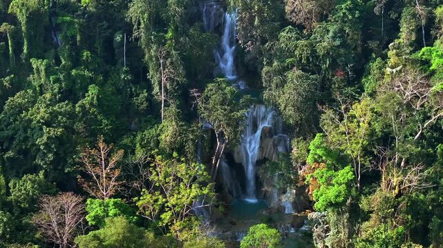 Aerial view of a Beautiful Kuang Si Waterfall in Luang Prabang, Laos. Top View Drone Shot of Lush Jungle in Lao.