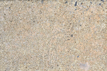 Fototapeta premium Rough beige concrete texture background with small dark speckles, creating a natural, rugged look