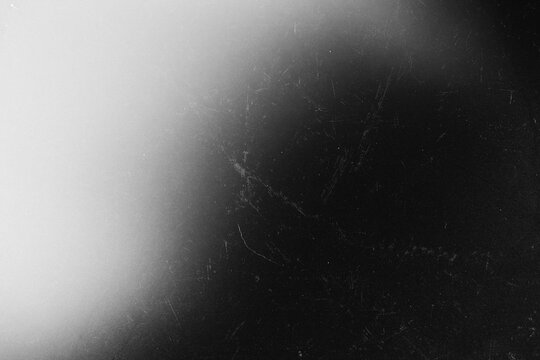 Black and White Film Grain Texture with Soft Light Gradient and Scratch Overlay
