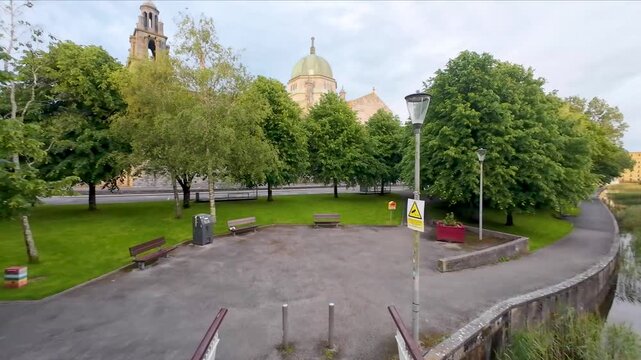 Majestic Galway Cathedral reflected in peaceful Corrib riverside landscape showcasing historic Irish architecture, serene nature, vibrant tourism and cultural heritage beauty
