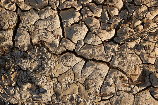 Cracked dry soil caused by El Ni&ntilde;o climate phenomenon. Drought, water scarcity, extreme weather impact on land. Climate change, desertification, environmental crisis, ecosystem stress global warming