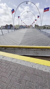 Queen Emma pontoon bridge opening and swinging away in Willemstad, Curacao.